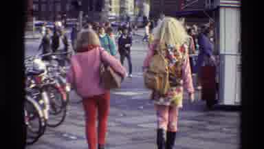 Denmark (1982): Two Women Walking Down A Sidewalk With Other People Around