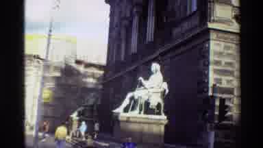 Denmark (1982): Amid Old Stone Building Two Aged Statues Stand Tall Over People