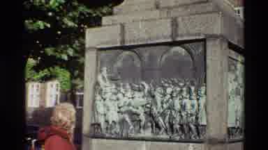 Denmark (1982): Elderly Woman Visits A Worn Stone Monument Of A Revered Male