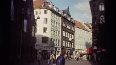 Denmark (1982): People Walking And Commuting Down A Busy Avenue In A City