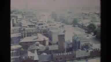 Denmark (1982): Several Cars Moving In A City With Old Architecture With Trees And