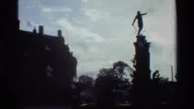Denmark (1982): A Statue With Pool And Public Fountain Sits In An Urban Area