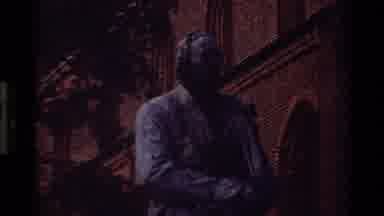 Denmark (1982): A Large Statue By A Building And Someone Feet Walking
