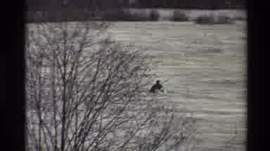Sacramento California USA (1982): Single Kayaker Struggling To Paddle Through