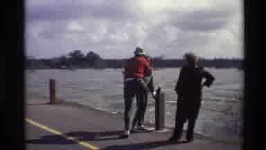 Sacramento California USA (1982): Three Adults Stand By A Fence Watching The Great