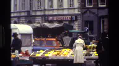 Denmark (1983): People Walking Around Market Outside With Band Playing Nearby