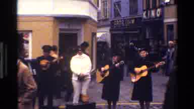 Denmark (1983): People Playing Music In A Market