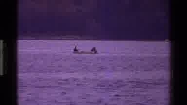 Denmark (1983): men canoeing thru canals around buildings