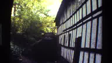 Denmark (1983): A Waterfall Against A Building With Trees Around It