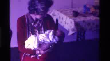 California USA (1975): Grandmother Holding Beautiful Baby In Arms While Sitting In