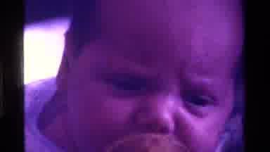 California USA (1975): A Mother Cuddles And Kisses A Baby Boy With A Pacifier In