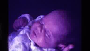 CALIFORNIA USA-1975: Baby Being Rocked To Sleep And Offered Pacifier