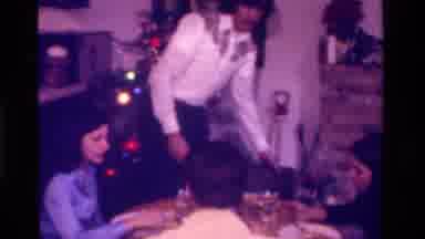 California USA (1975): A Family Sit Down To Eat A Christmas Dinner Together