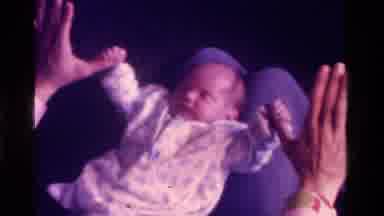 California USA (1975): Mom Or Dad Playing With Sleeping Babies Hands And Shaking
