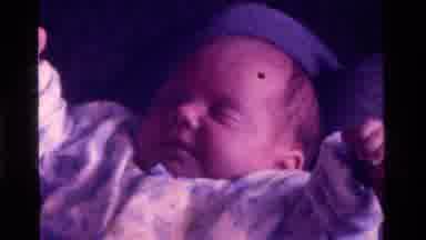 California USA (1975): Baby's Sleeping But Being Disturbed By Mothers Hand It