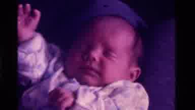 California USA (1975): Sleeping Newborn Baby Having Its Lips Played With By