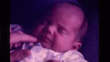 California USA (1975): Interacting With Newborn Baby By Tickling Their Face And