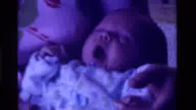 California USA (1975): Mother Taking Care Of Newborn Baby Who Is Smiling And Happy