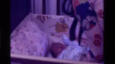 California USA (1975): Mother Puts Baby To Sleep In Crib As The Baby Fell Asleep