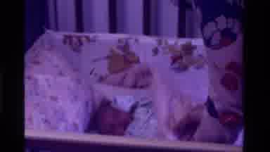 California USA (1975): Infant Getting Covered Up And Tucked Into Bed To Sleep For