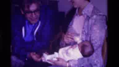 California USA (1975): Elderly Couple Holds Feeds And Interacts With An Infant