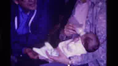 California USA (1975): Grandmother Feeds Grandson While Her Husband And Grandson