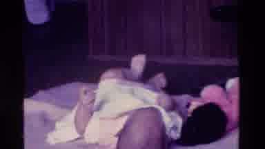 California USA (1975): Baby Bed Blanket Teddy Wriggling No Parents White Pink