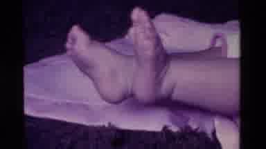 California USA (1975): A Baby Laying On A Blanket Trying To Raise His Upper Body