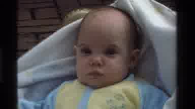 California USA (1975): Infant Frowning And Wrapped In Blanket While Awake