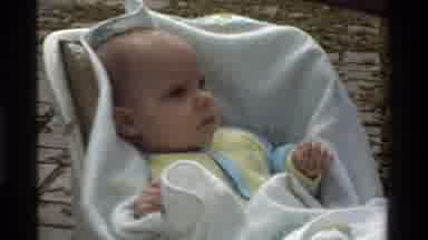 California USA (1975): Baby Sitting In A Car Seat Making Face For The Camera