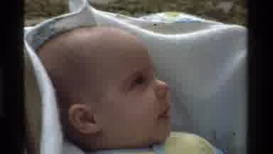 California USA (1975): A Person Puts A Cloth Over A Baby's Head To Protect Him