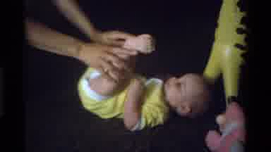 California USA (1975): Parent Playing With Cute Little Baby In Yellow With Yellow
