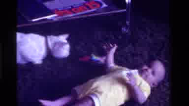 California USA (1975): Cat Playing With Baby On The Floor