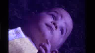 California USA (1975): A Baby Lies On Its Back And Then Its Belly On A Shag Carpet