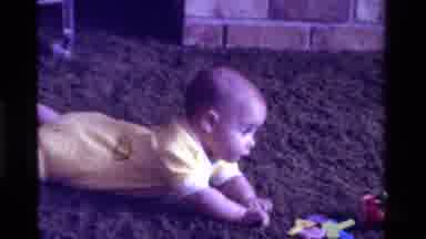 California USA (1975): A Small Kid Playing With Toys