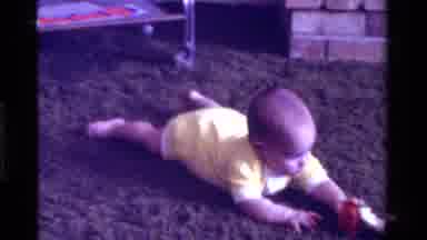 California USA (1975): Baby In A Living Room On A Carpet Wearing A Yellow Onesie