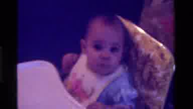 California USA (1975): A Baby Eating Porridge In His Chair