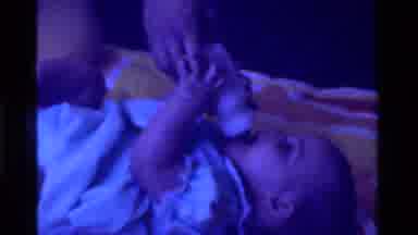 California USA (1975): Baby Receiving And Taking A Bottle Of Milk To Drink From
