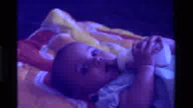California USA (1975): Smiling Baby Drinks A Bottle