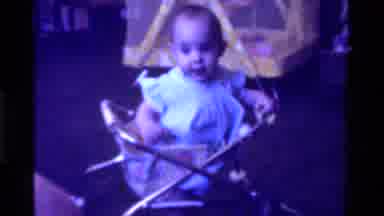 California USA (1975): Baby Walking Taking Steps With Her Toy Baby All Smiles