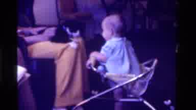 California USA (1975): Cat Getting Pet In Persons Lap Gets Touched By A Baby In A