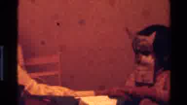California USA (1977): Child Wearing Homemade Owl Mask Playing With A Mother And