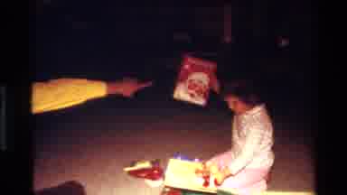 California USA (1977): A Child Is Arranging Books With Her Father Instructions