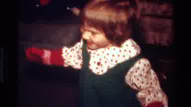 California USA (1977): Smiling Child Wearing Mittens And Clapping