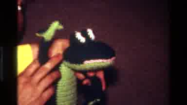 California USA (1977): Person Playing With Crocodile Puppet And A Child Playing