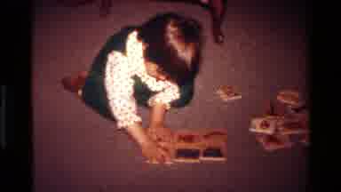 California USA (1977): Two Scenes One Of A Little Girl Enjoy Her Puzzle And A