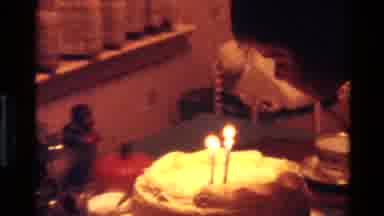 California USA (1977): Three Year Old Girl Blowing Candles Off Cake On Her