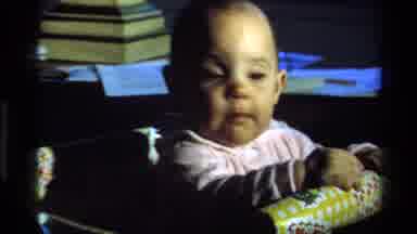 California USA (1977): Baby Playing In A Play Pen