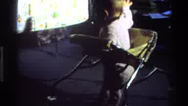 California USA (1977): A Few Months Old Child Plays And Jumps On A Walker In The