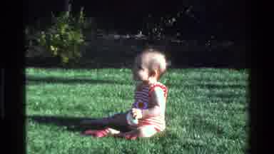 California USA (1977): A Baby In A Red And White Striped Jumper With Red Socks